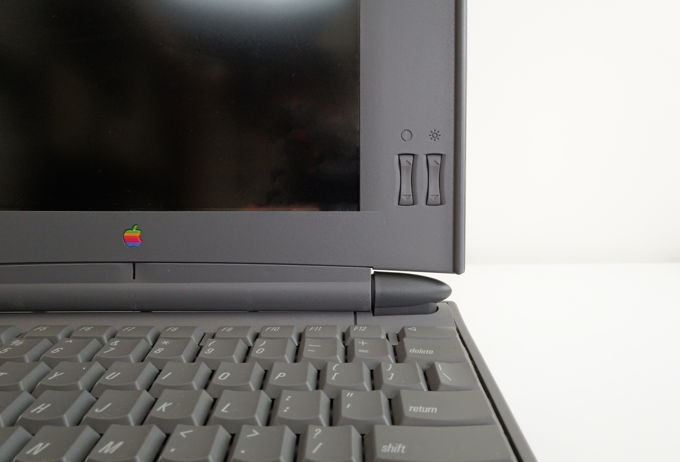 Macintosh PowerBook 540c front detail; showing keyboard and brightness/contrast controls